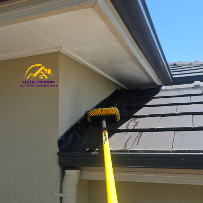Klean Kingdom agitating years of dirt and organic growth from the eaves and gutter line during a pre-sale house wash in Manly, Sydney